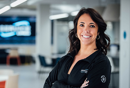 An image of a female employee with a Service Express jacket on smiling