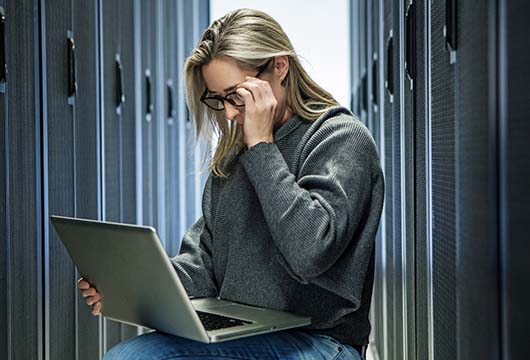 Engineer Holding Glasses in Data Centre