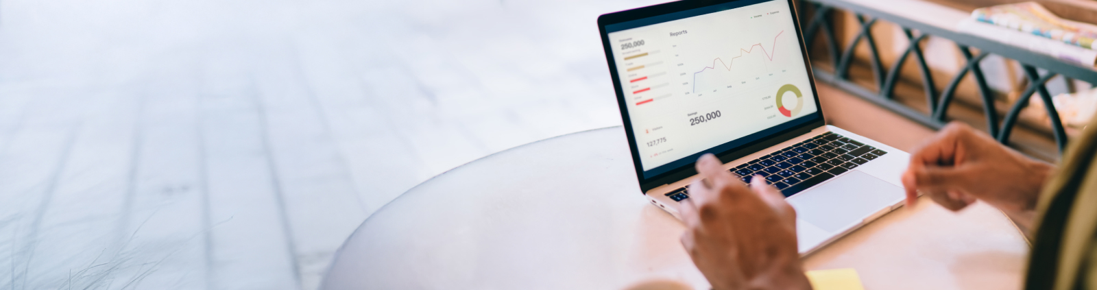 An image of a dashboard with charts and graphs on a laptop