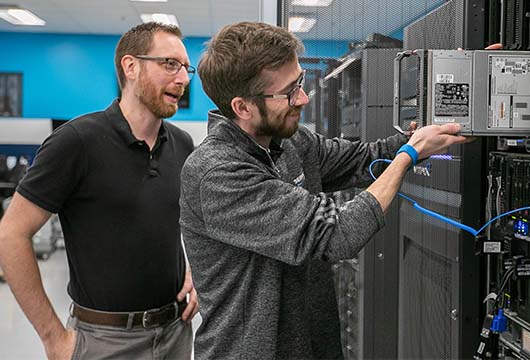 Two Engineers Take Parts Out of Server