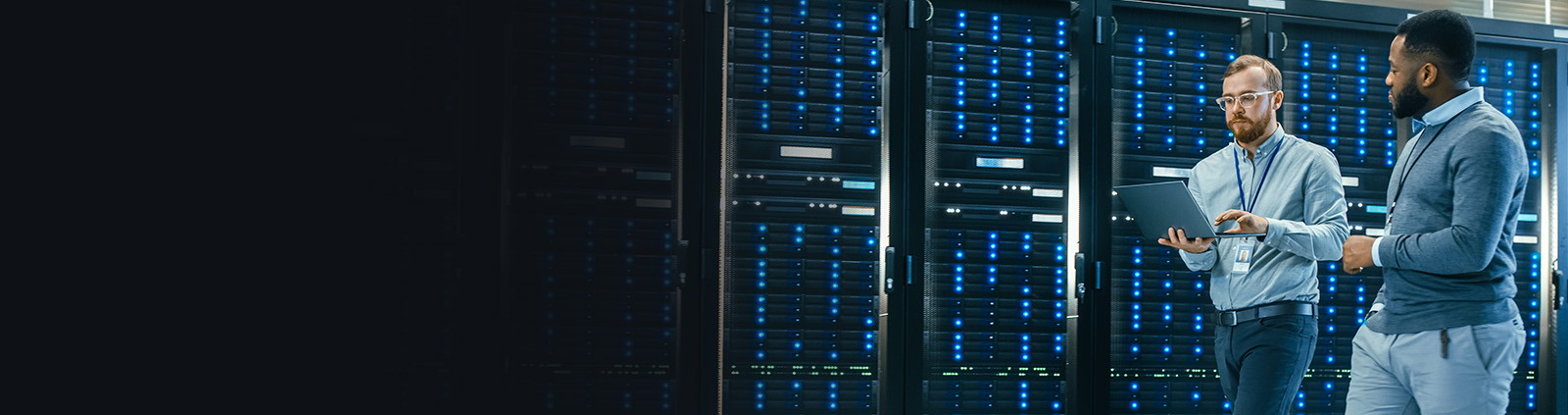 Two Professionals Walking with Laptop in Data Center