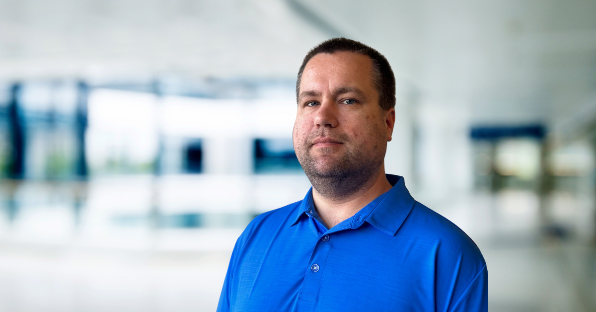 Craig Edwards headshot in blue polo shirt