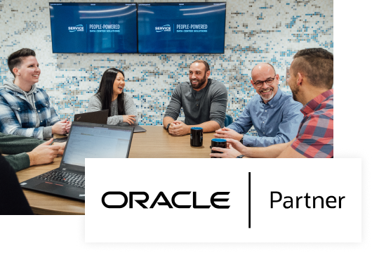 An image of Service Express employees around a table with Oracle | Partner logo overlayed