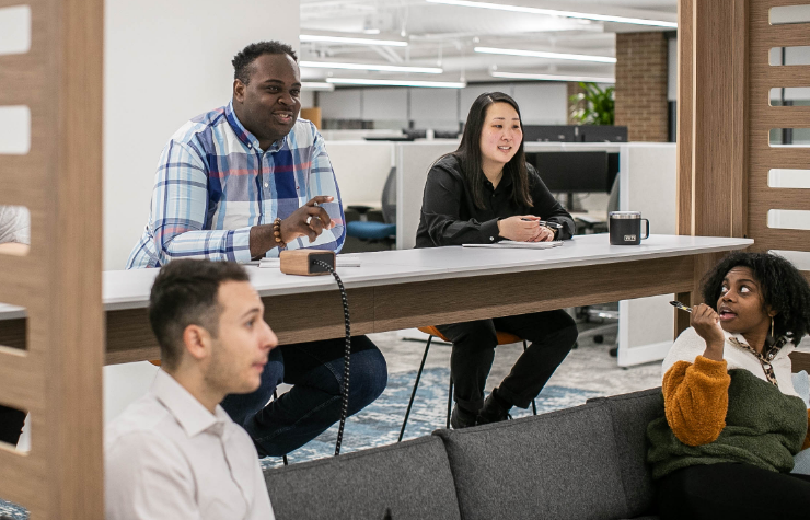 An image of a group of diverse team members learning